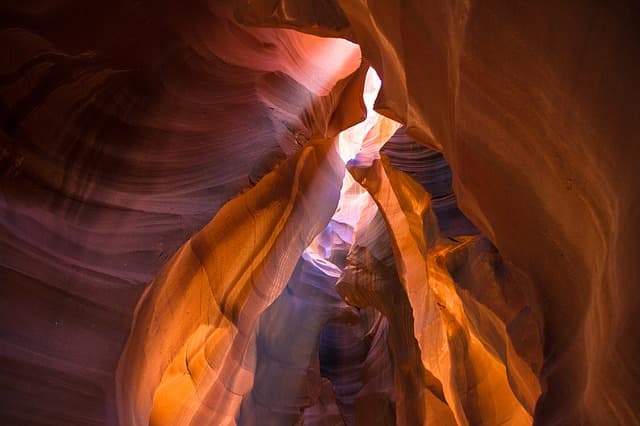 Sunlit sandstone walls of a narrow slot canyon